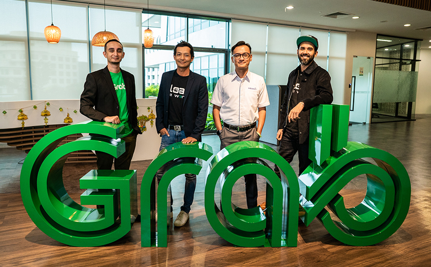Joey Azman with three men in front of Grab sign