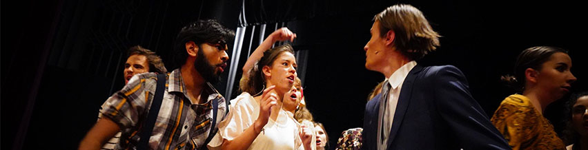 Group of Trinity students performing on the stage in one of the musical performances