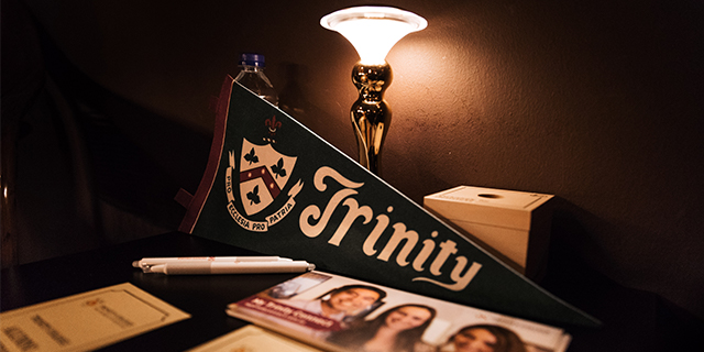 A Trinity flag in front of a lamp.
