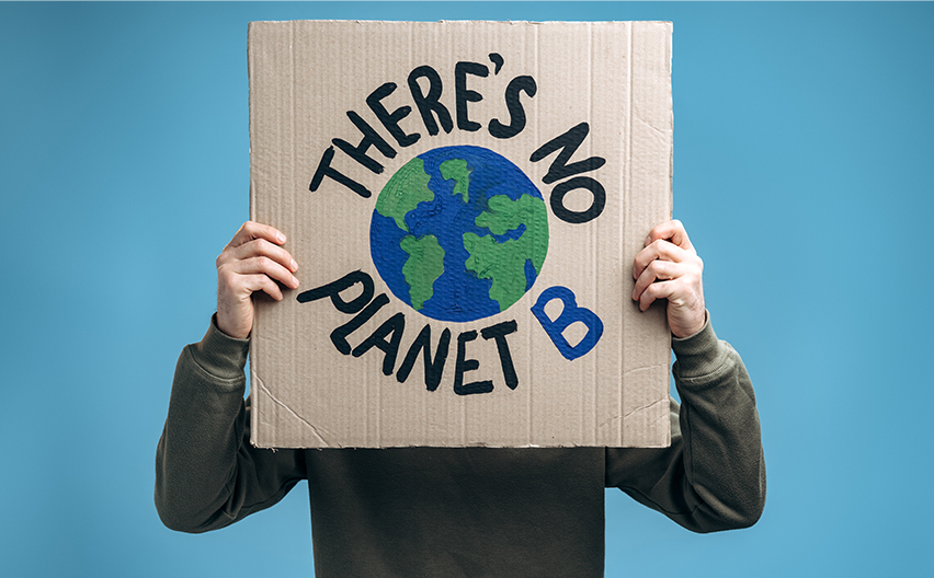 Cardboard sign saying there's no planet B