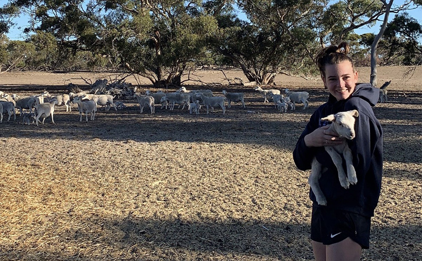Edwina Crozier with sheep on her family farm in Keith