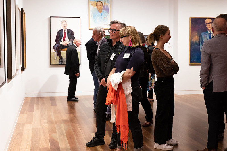 Guests attending the opening of Face Me - Portraits of a Collegiate Community, 27 April 2023