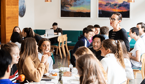 Happy students and staff in the dining hall