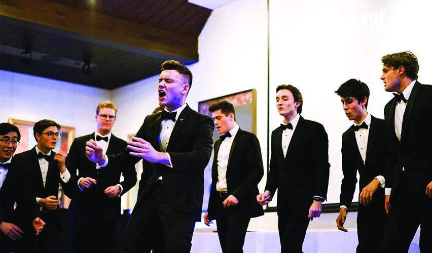 Trinity-Tiger-Tones-web.jpg Candid image of Trinity's a capella group Tiger Tones performing on the stage.
