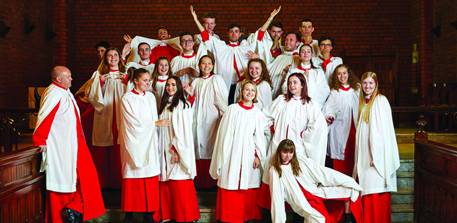 Trinity's choir posing as a group after the weekly Evensong service in our chapel during term