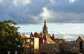 Two boys and three girls – a group of international students smiling on campus