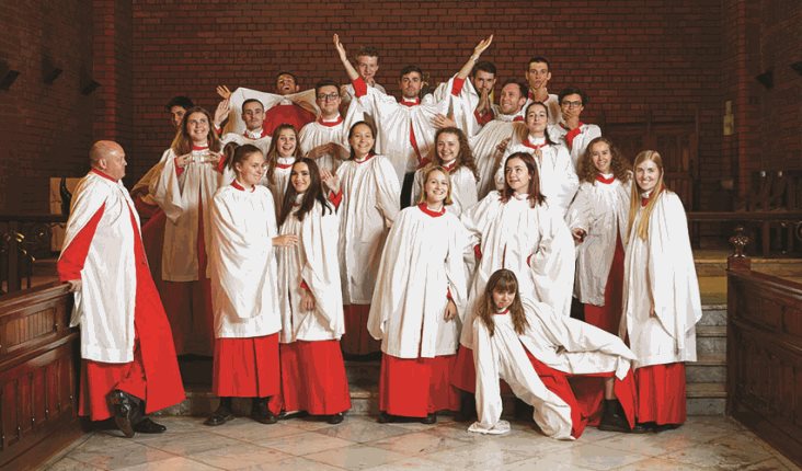 Trinity's choir posing as a group after the weekly Evensong service in our chapel during term