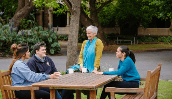 indigenous students and staff engaged in conversation on the Trinity College grounds