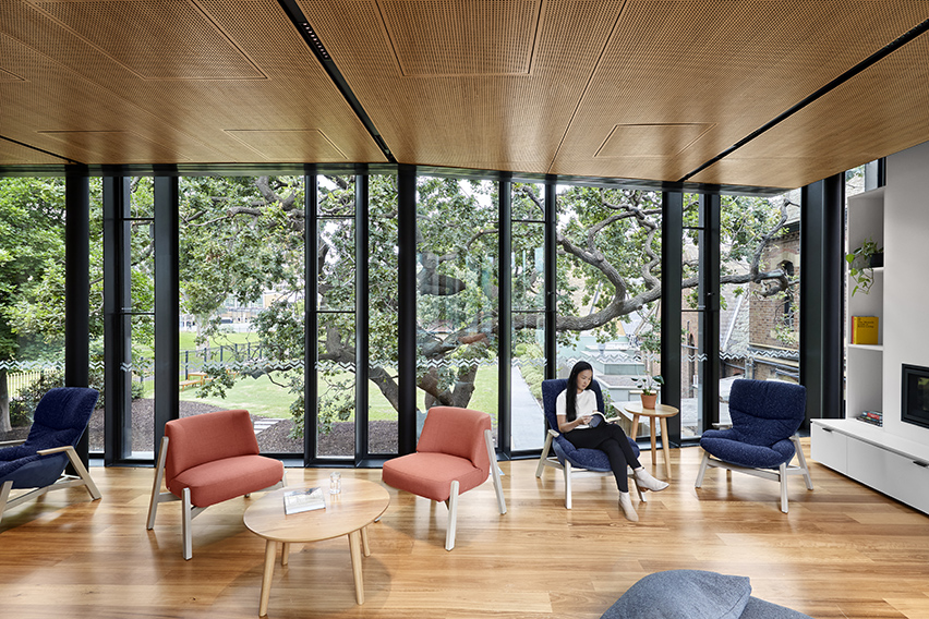 Image of girl sitting in our common rooms and reading a book