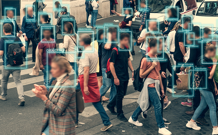 People walking with blurred faces and squares drawn around heads