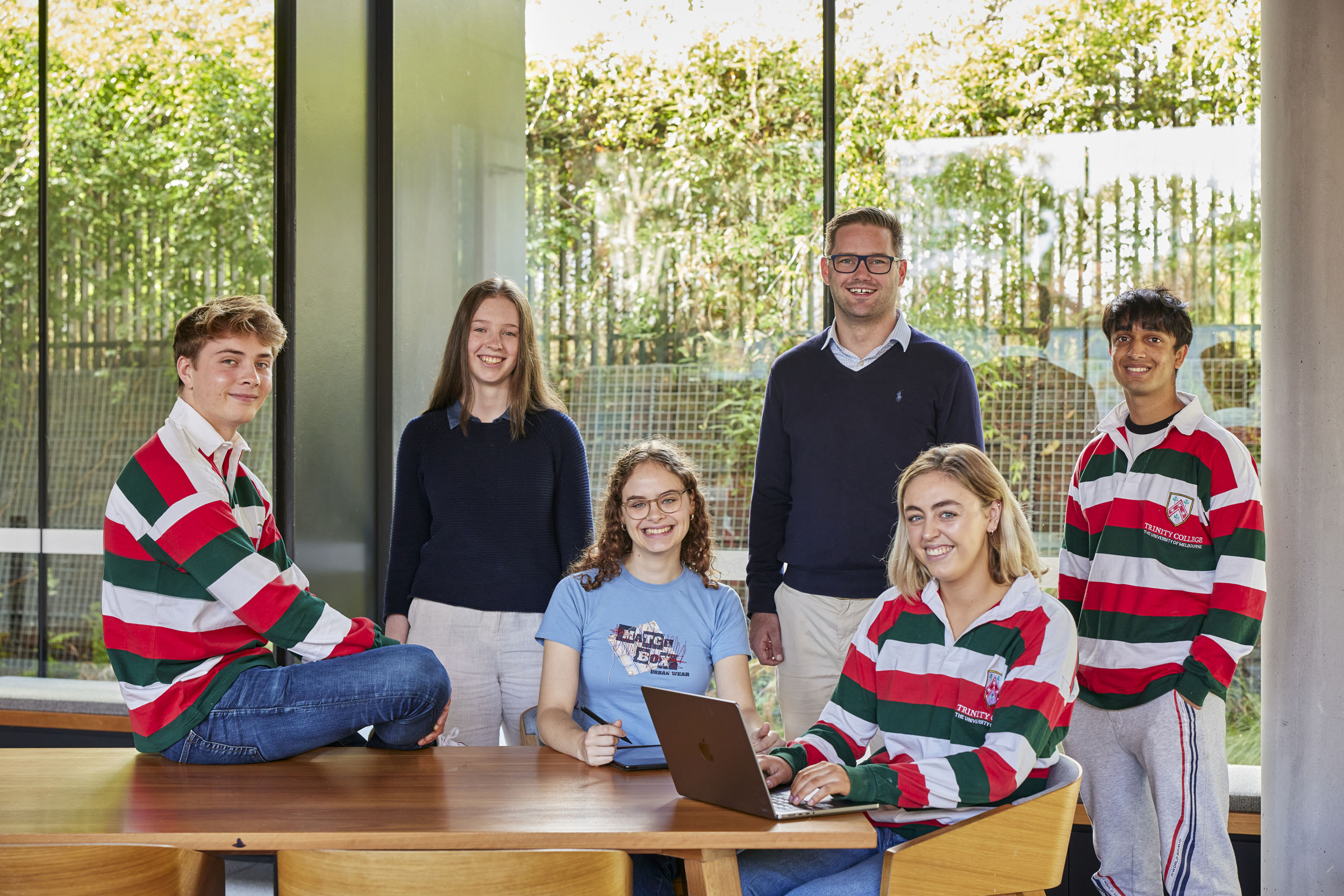 Students in a building around a computer