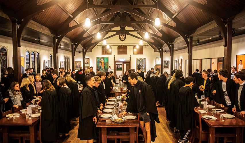Residents at the Trinity College about to start eating their meal at the formal dining hall.