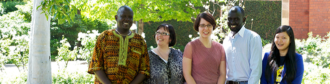 Two boys and three girls – a group of international students smiling on campus