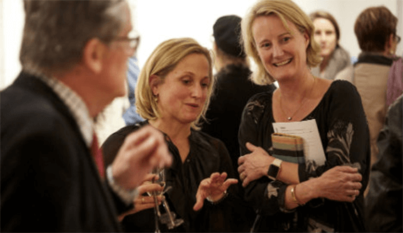 Engaged alumni enjoying talking at a Trinity College alumni event